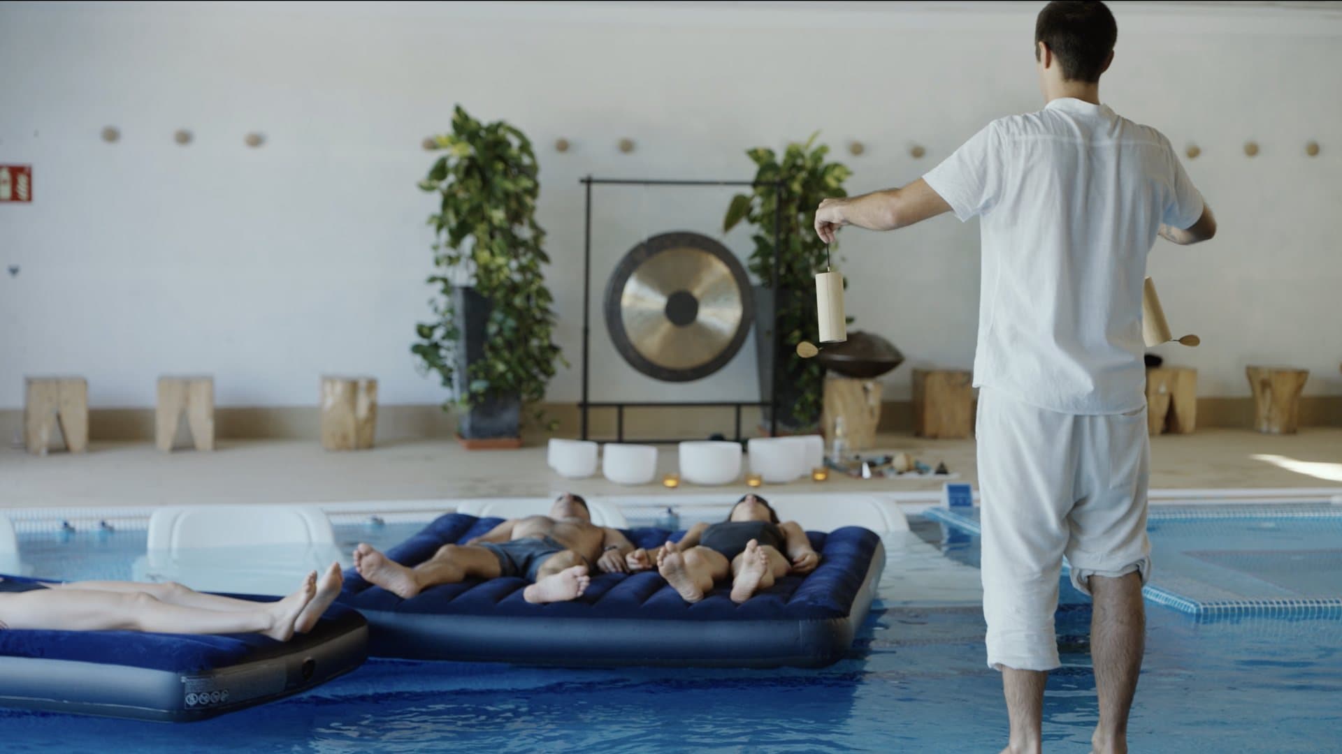 Artiem Audax — the facilitator walks the pool with koshi chimes during the sound session